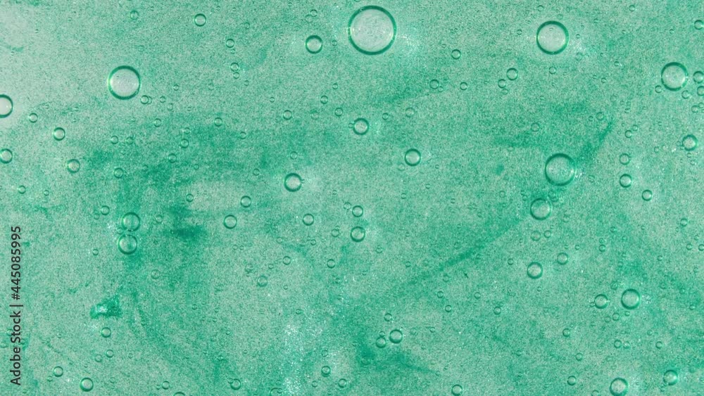 Macro Shot of air Bubbles in Transparent Cosmetic Liquid Gel Cream. Green Cosmetic Fluid texture With Bubbles. Slow motion . High quality 4k footage Macro Shot of air Bubbles in Transparent Cosmetic Liquid Gel Cream. Green Cosmetic Fluid texture With Bubbles. Slow motion . High quality 4k footage