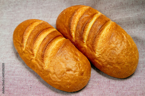 Two fresh loaves of bread with a golden crust.