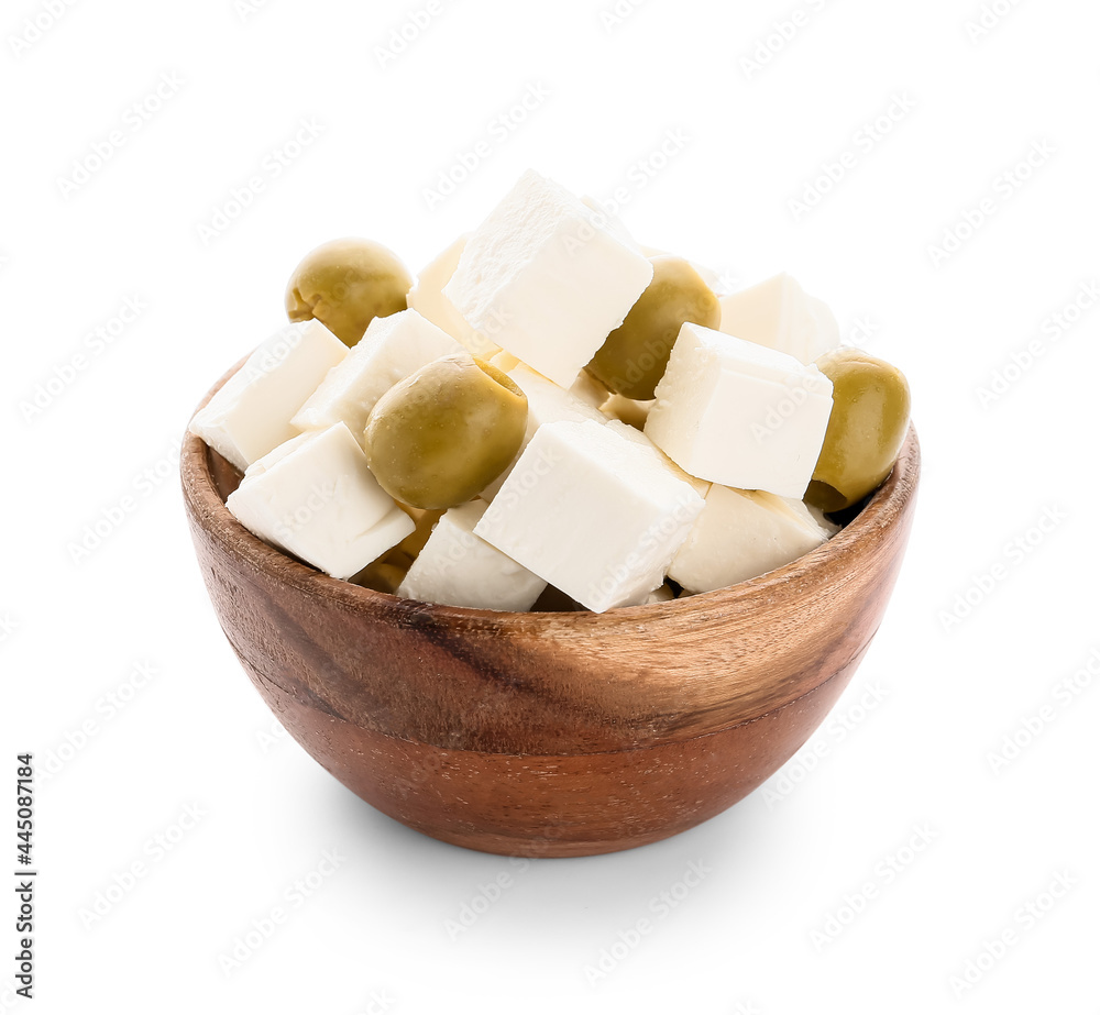 Wooden bowl with pieces of feta cheese and green olives on white background Wooden bowl with pieces of feta cheese and green olives on white background