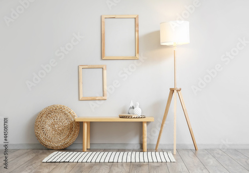 Interior of stylish light room with bench and floor lamp