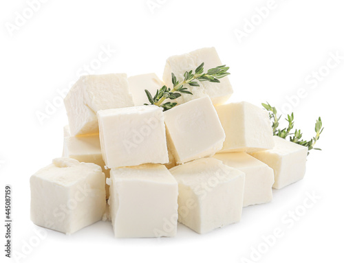 Pieces of delicious feta cheese with thyme on white background