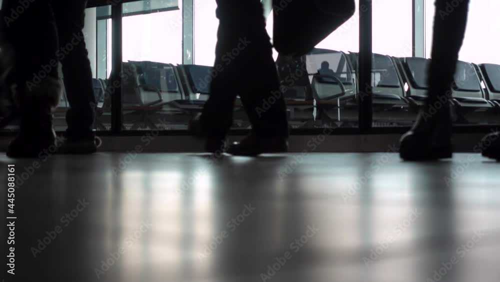 4K ground level video clip of anonymous people walking through an airport terminal with suitcases, bags and baggage 4K ground level video clip of anonymous people walking through an airport terminal with suitcases, bags and baggage