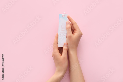 Woman with bookmark on color background © Pixel-Shot
