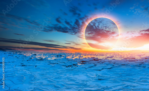 Ring of Fire - Solar eclipse with ice on the ocean shore "Elements of this image furnished by NASA" © muratart