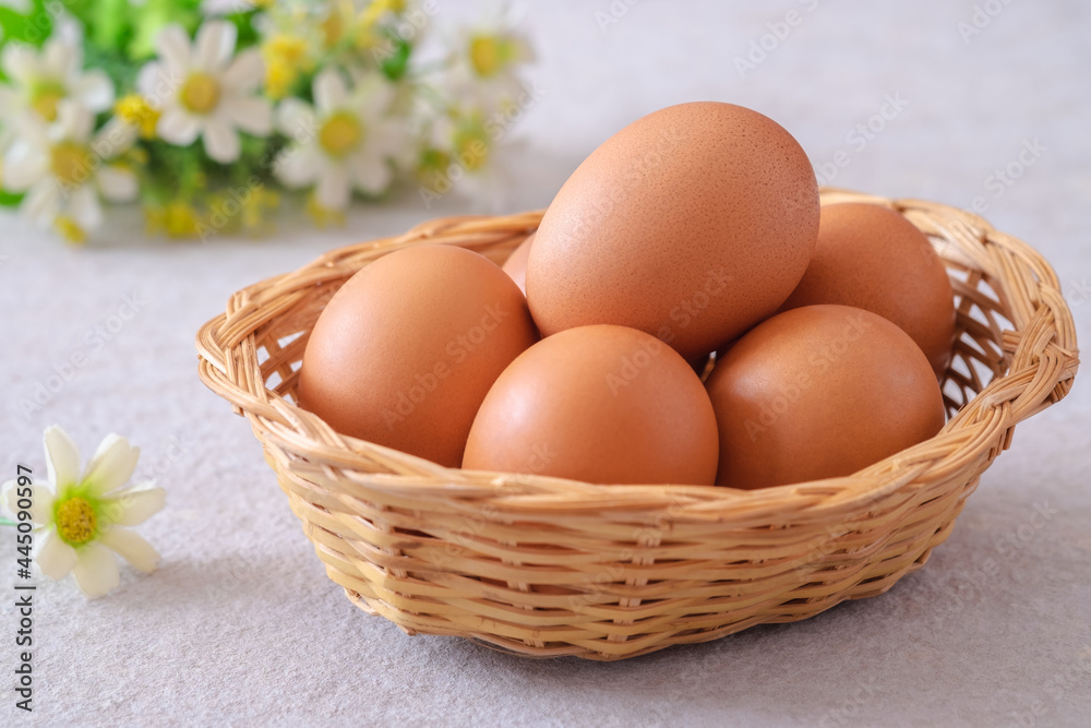 Raw chicken eggs in wicker basket. Raw chicken eggs in wicker basket.