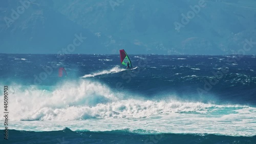 Cinematic view of windsurfers sailing across the ocean, Scenic Jaws beach 4K USA
