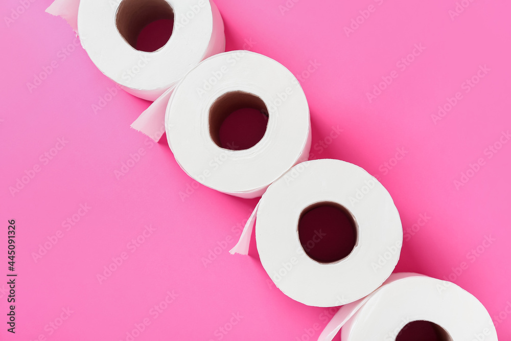 Rolls of toilet paper on color background