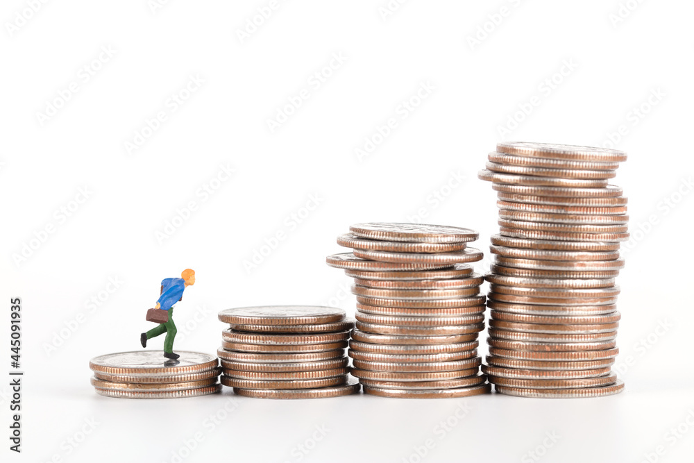Increasing coins and a doll running up on a white background Increasing coins and a doll running up on a white background