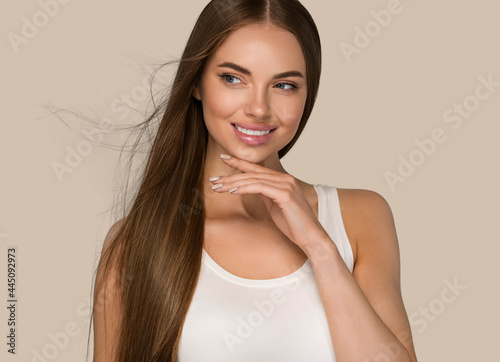 Fotografie Beautiful woman with long smooth brunette hair clean beautiful skin