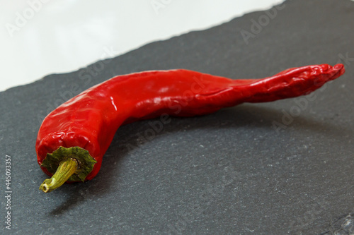 Red hot pepper on the stone cutting board.