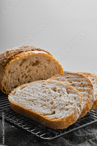 Closeup view of artisan whole grain wheat bread cut on slices on kitchen table