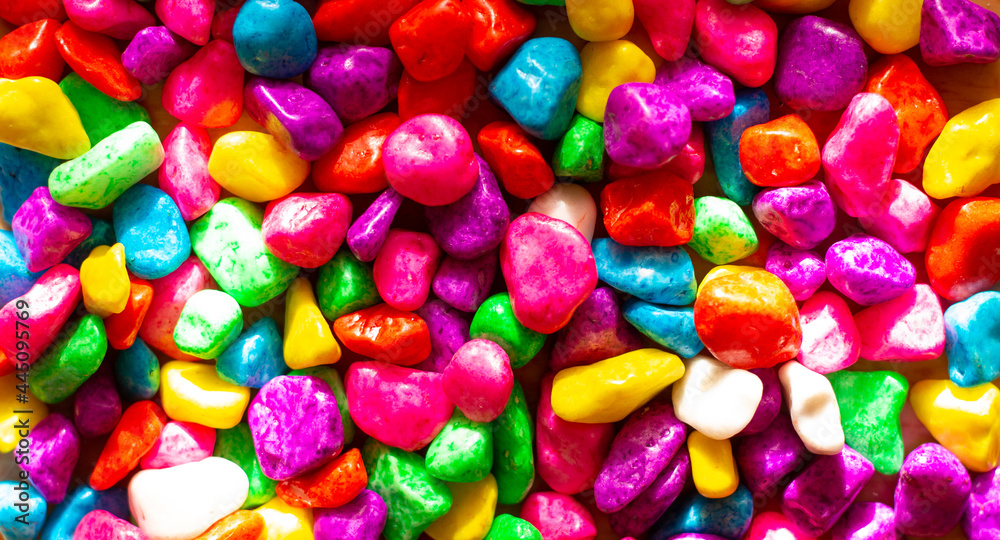 Background and wallpaper of multi-colored small bright stones. Colored sweet multicolored sweets Background and wallpaper of multi-colored small bright stones. Colored sweet multicolored sweets