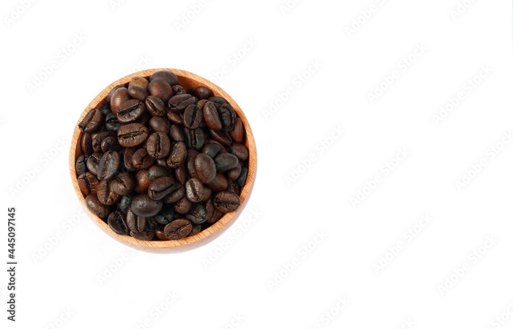 Fototapeta premium Coffee beans in a wooden bowl isolated on a white background, top view
