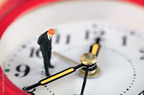 Businessman thinking about problems in alarm clock