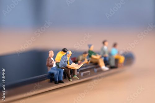 Various dolls sitting on mobile phones