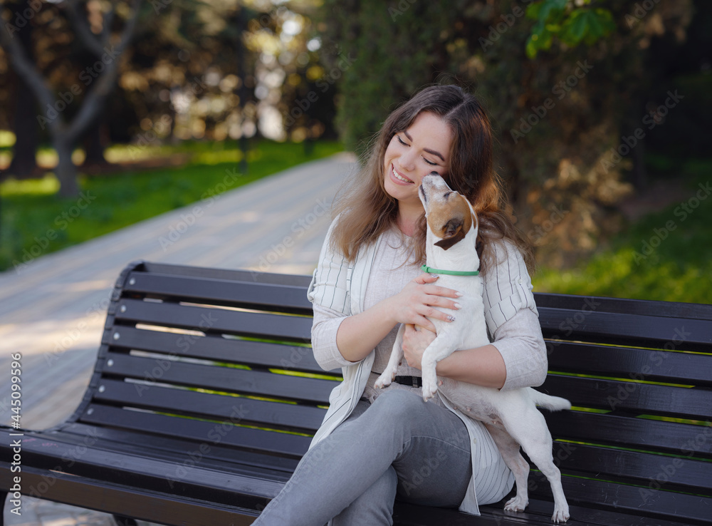 Young woman with her cute Jack Russell Terrier outdoor. Young woman with her cute Jack Russell Terrier outdoor.