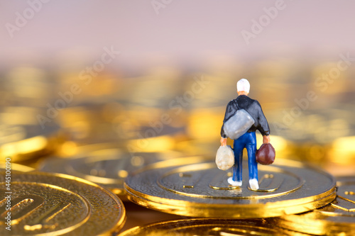 Miniature doll model walking on gold coins