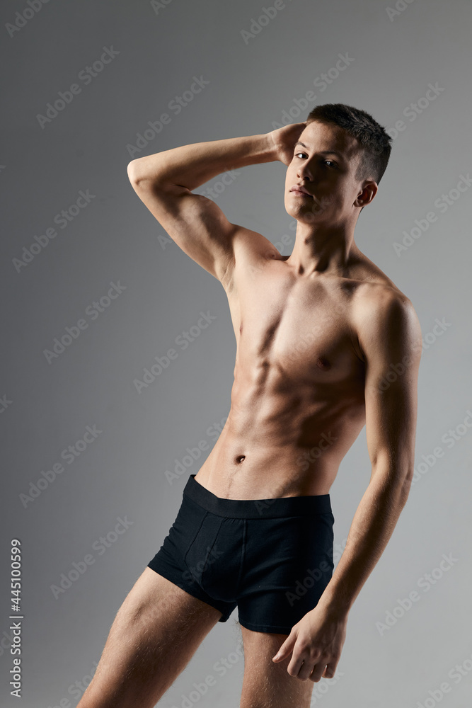 athlete black panties she holds her hand behind her head and an inflated torso gray background model athlete black panties she holds her hand behind her head and an inflated torso gray background model