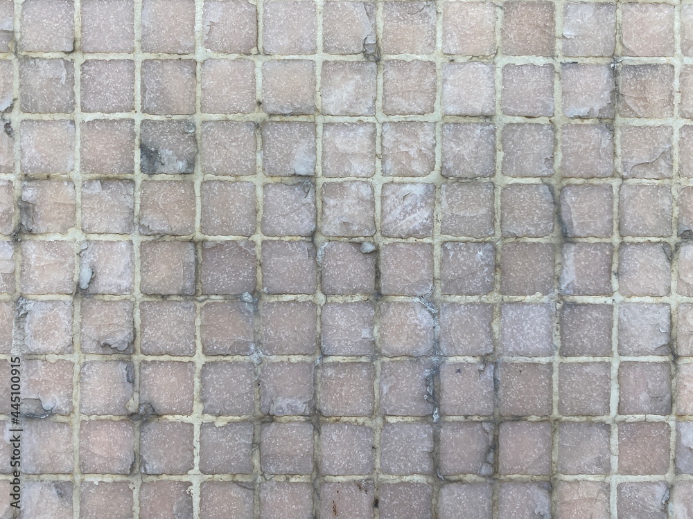 Small square tiles on an outdoor wall. - obrazy, fototapety, plakaty 