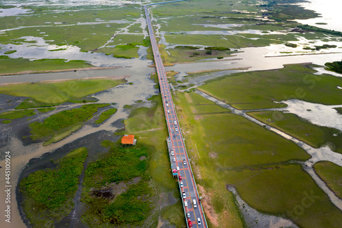 Fotografie Beautiful aerial view of traffic on elevated road and tollway surrounded green r