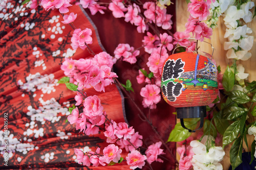 Decorative japanese style floral background with red fabric and lantern. Blurred image for a site about the wealth, creativity and culture of the east photo