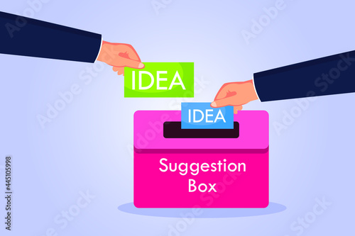 Suggestion vector concept. Hands putting idea suggestion paper into a box photo