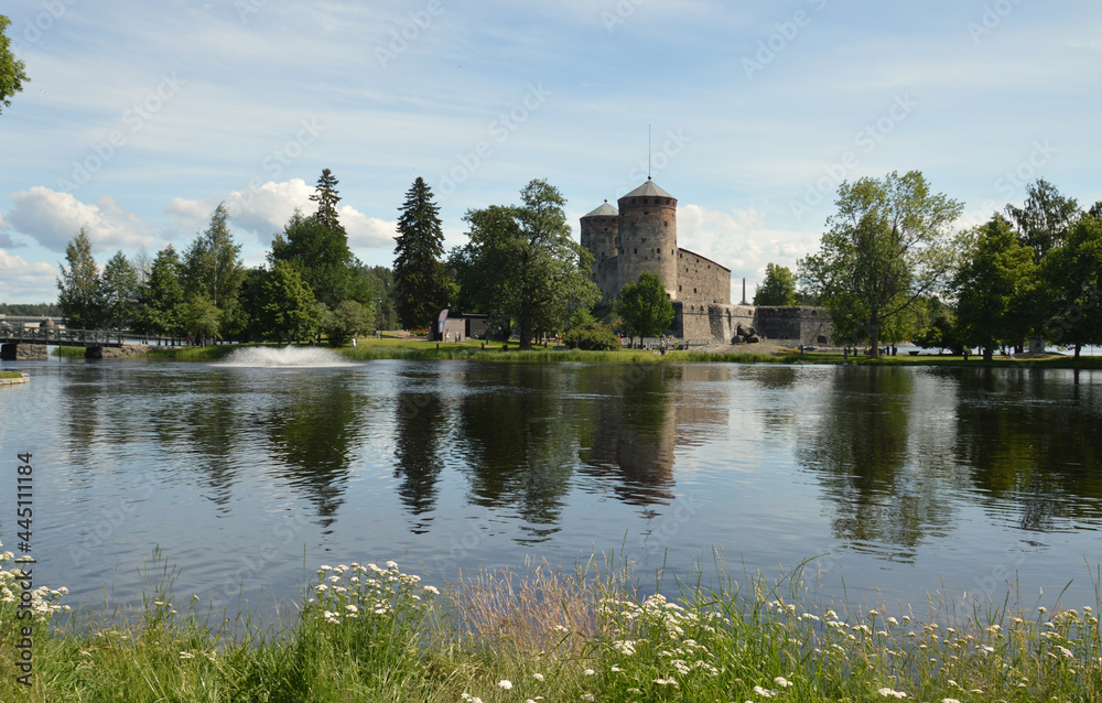 Idyllic view across the lake towards Olavinlinna Castle in the small town of Savonlinna, Finland. The castle was founded in 1475. Idyllic view across the lake towards Olavinlinna Castle in the small town of Savonlinna, Finland. The castle was founded in 1475.