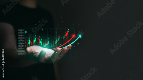 Businessman trader is holding a growing virtual hologram stock. Stock market cryptocurrency and investment concept. Business growth and strategy