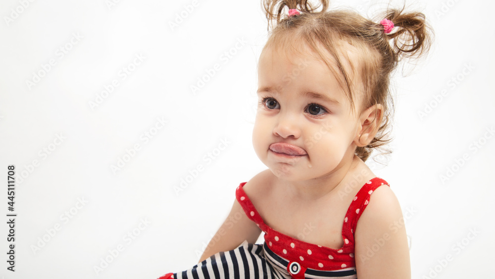 Studio portrait of cute, adorable, sad, upset, crying caucasian toddler girl in dress on isolated white background Studio portrait of cute, adorable, sad, upset, crying caucasian toddler girl in dress on isolated white background