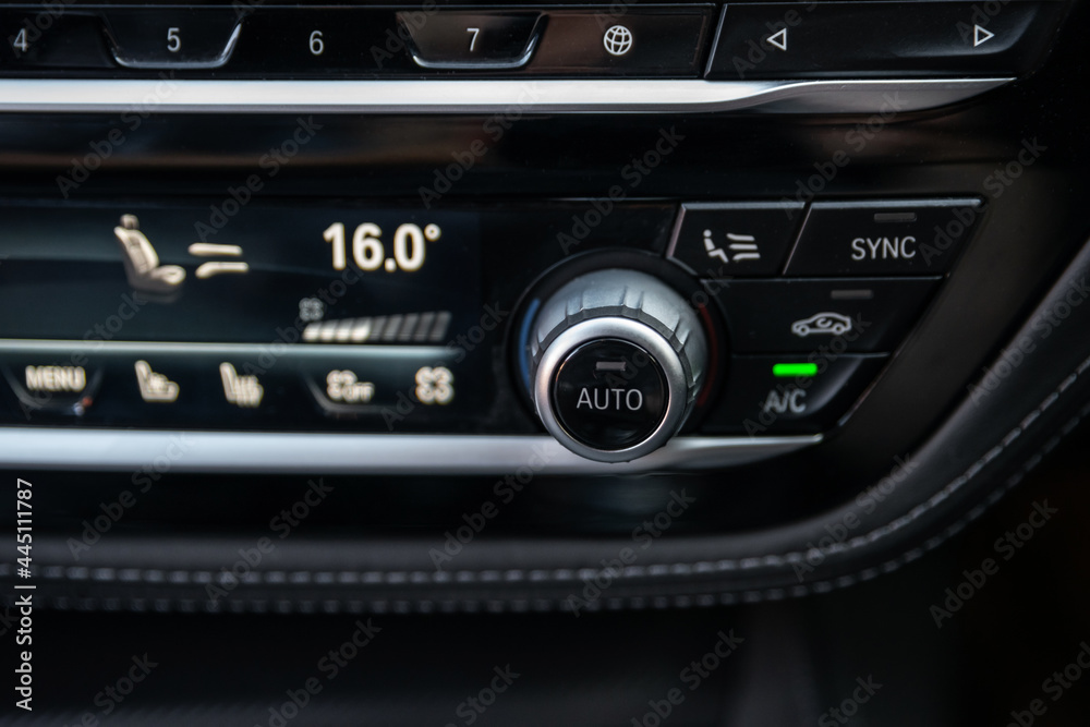 Air ventilation system and air conditioning button inside a car. Car climate control system. Display indicates temperature inside the car. Cooling air in the car
