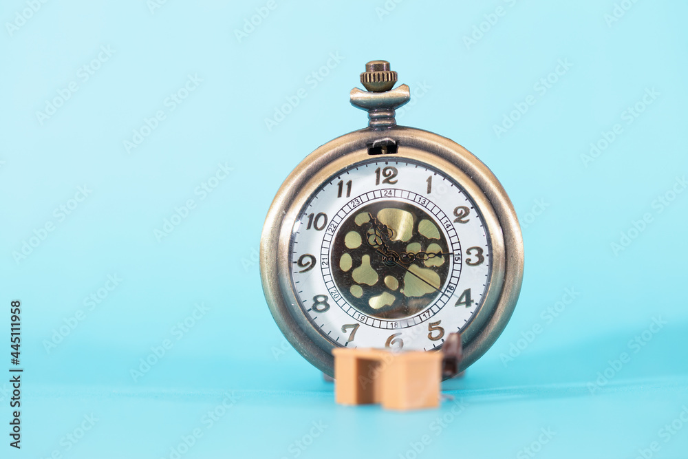 Pocket watch and work station on blue background Pocket watch and work station on blue background