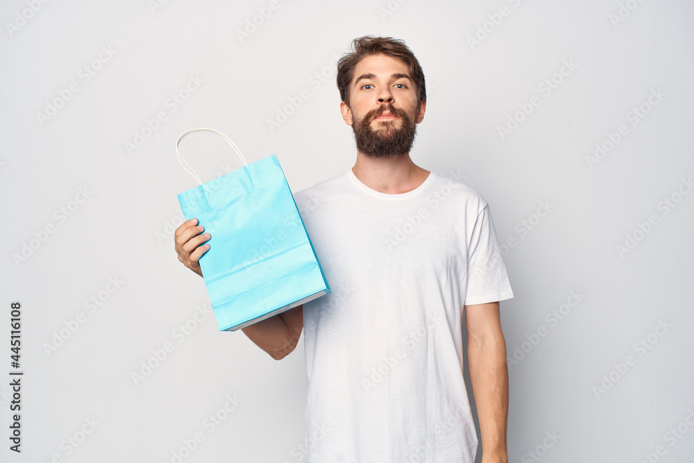 a man with a blue package in his hands shopping shop fashion clothes a man with a blue package in his hands shopping shop fashion clothes
