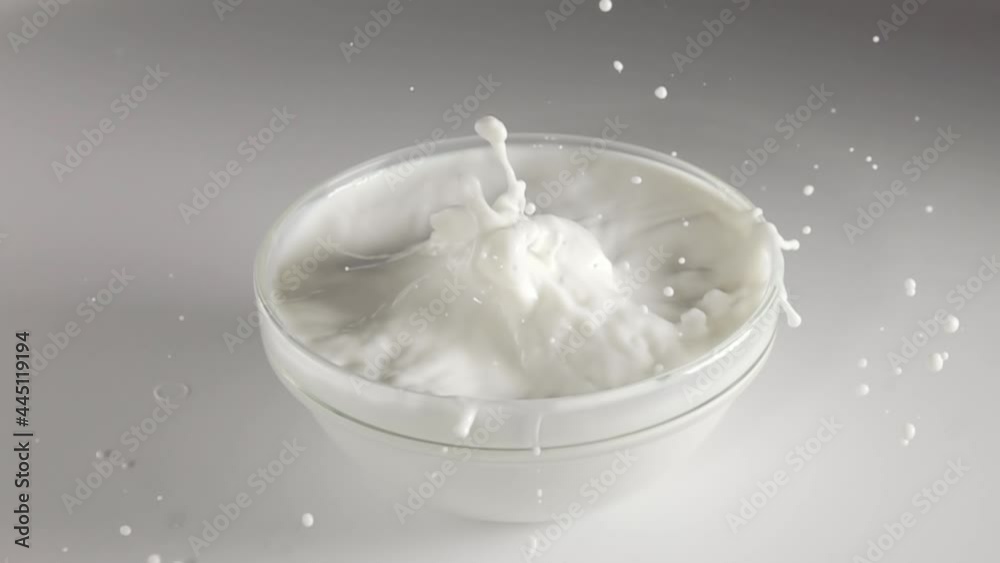 Slices of Strawberries Fall Into a Bowl of Milk. Slow Motion Slices of Strawberries Fall Into a Bowl of Milk. Slow Motion