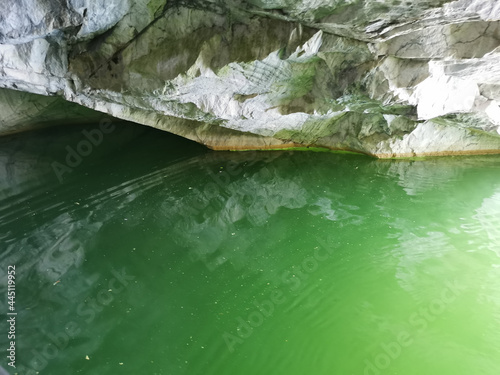 The wall of the grotto, reflected in the emerald water of the Marble Canyon in the Ruskeala Mountain Park.
