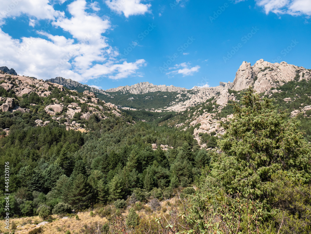 Panoramic view of La Pedriza on the southern slope of the Sierra de Guadarrama in the community of Madrid. Spectacular orography composed of mountains and cliffs created with this peculiar stone Panoramic view of La Pedriza on the southern slope of the Sierra de Guadarrama in the community of Madrid. Spectacular orography composed of mountains and cliffs created with this peculiar stone