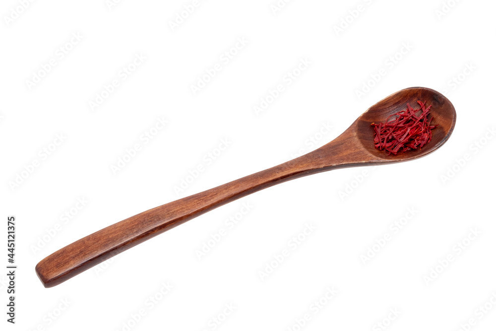 Saffron background. Close-up of red safran spice threads or strands in a rustic wooden spoon isolated on a white background. Clipping path.Macro.
