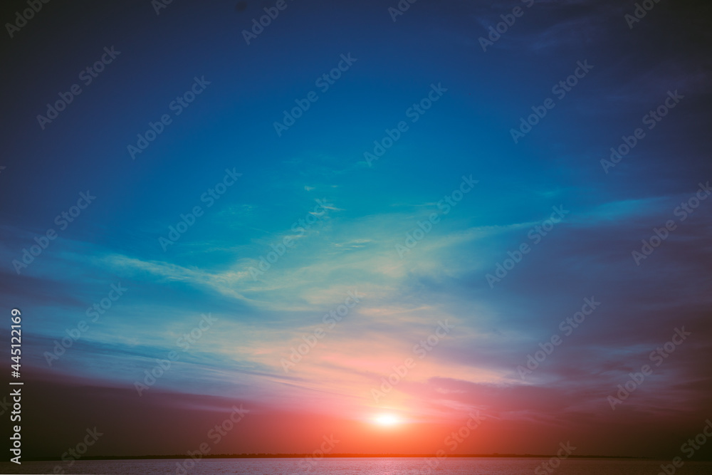 Colorful cloudy sky over the sea at sunset. Sky texture, abstract nature background