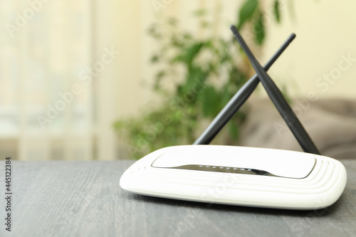 Wi-Fi router with external antennas on wooden table photo