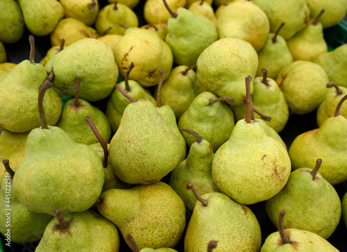 Fresh green pears background. Pile of pears on food market. Fruits. 