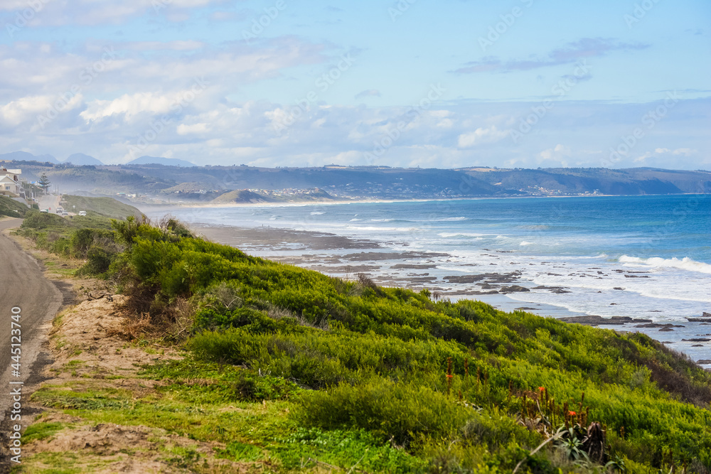 A view over the ocean from a walking path over the hill on a low tide A view over the ocean from a walking path over the hill on a low tide