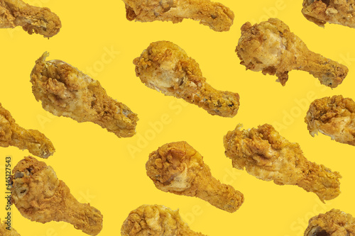 Seamless pattern with fried chicken legs. Template on the theme of fast food in pastel colors.
