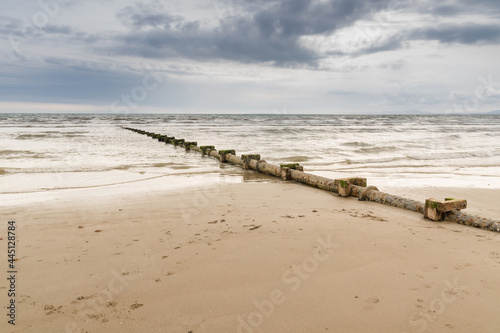 Sewage or waste water discharge pipe leading out to sea on a beach