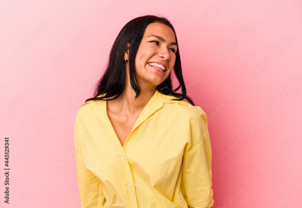 Young Venezuelan woman isolated on pink background laughs and closes eyes, feels relaxed and happy. Young Venezuelan woman isolated on pink background laughs and closes eyes, feels relaxed and happy.
