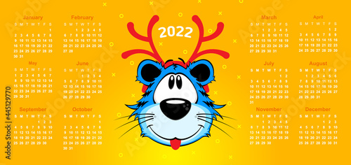 Happy new year 2022 calendar on yellow background. Cartoon blue tiger with red Christmas deer antlers. Vector, illustration