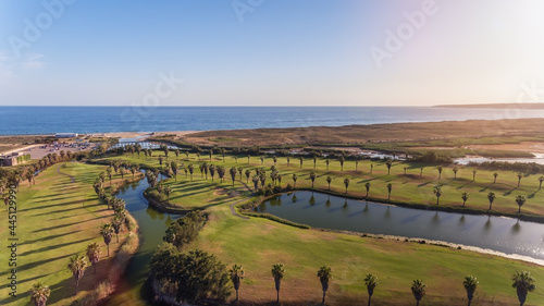 Green golf courses by the sea. Salgados beach. Portugal, Albufeira. Aerial view.