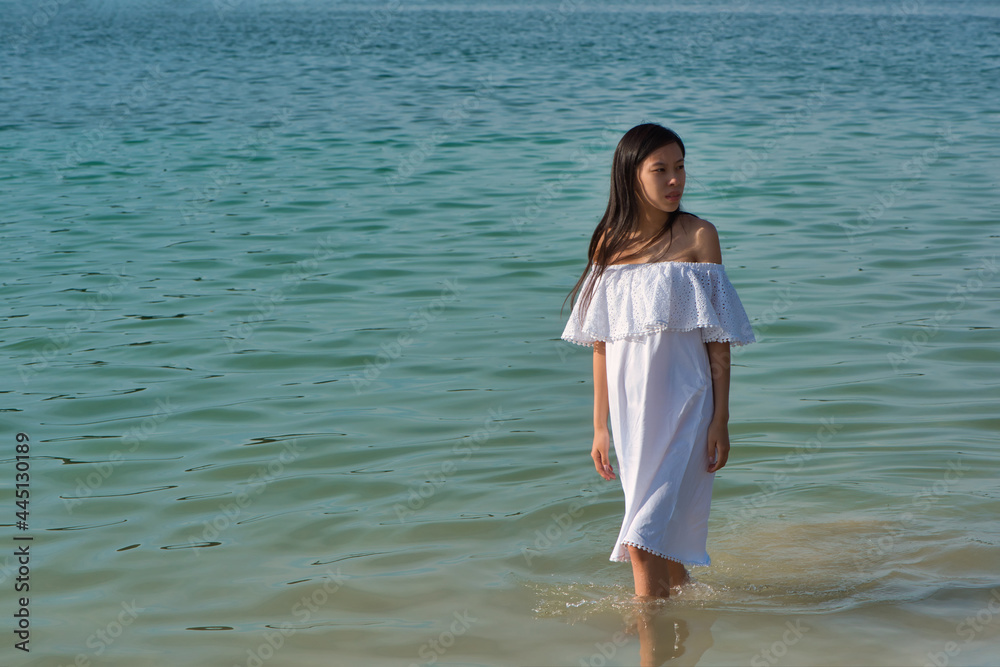 Young asian pregnant woman in a white sundress Young asian pregnant woman in a white sundress