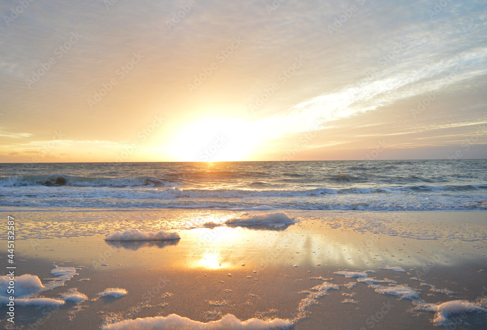 Beautiful landscape of sea foam on the shore of Naples beach during sunset hour Beautiful landscape of sea foam on the shore of Naples beach during sunset hour