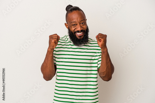 African american man with beard isolated on pink background cheering carefree and excited. Victory concept.