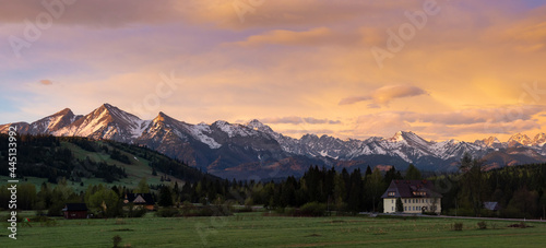 Fototapeta Naklejka Na Ścianę i Meble -  A beautiful panorama of the Bielskie Tatras. White mountain peaks in the distance Beautiful colors of the sky. View at sunset. Jurgow, Poland