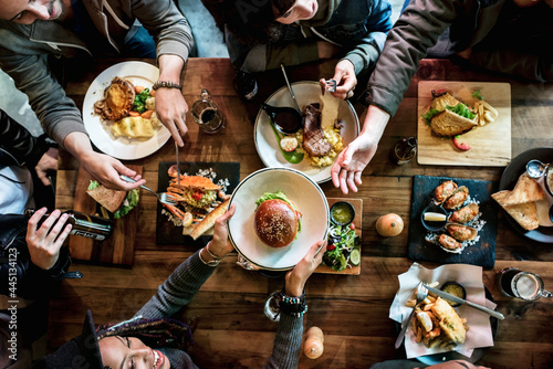 Group of friends eating together photo